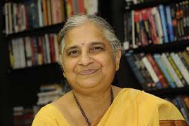 Sudha Murty in yellow saree smiling