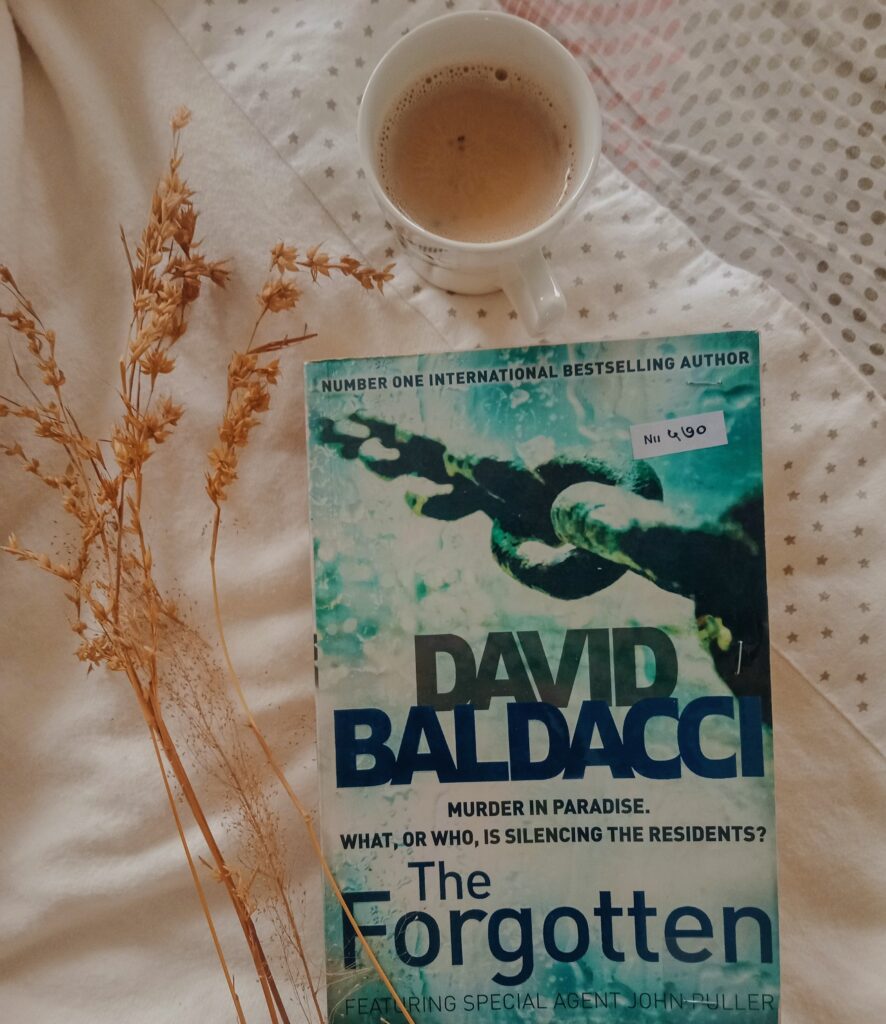 The Forgotten by David Baldacci is kept with a coffee