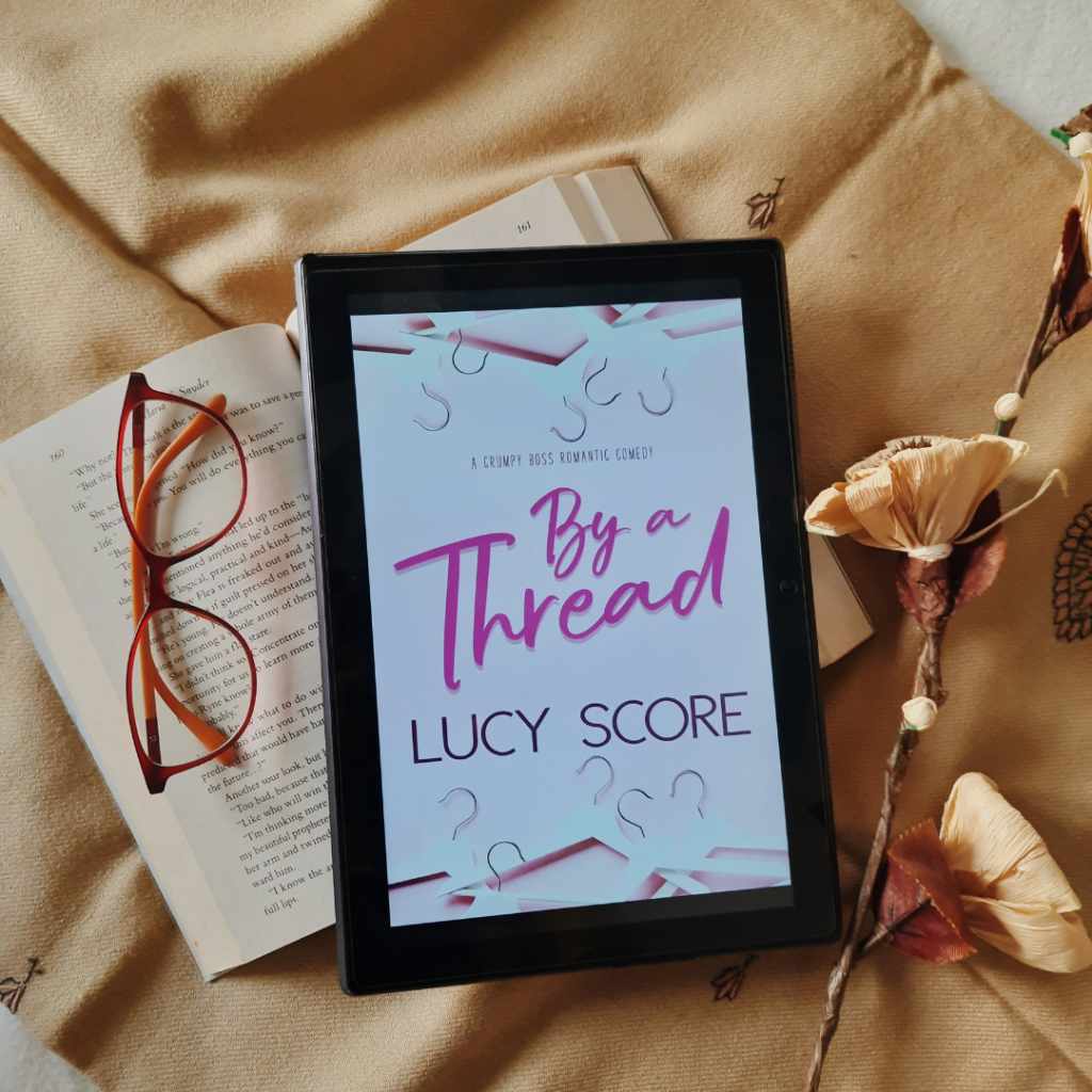 By A Thread by Lucy Score; 10 Best Feel-Good Books to read (Awesome Reads)